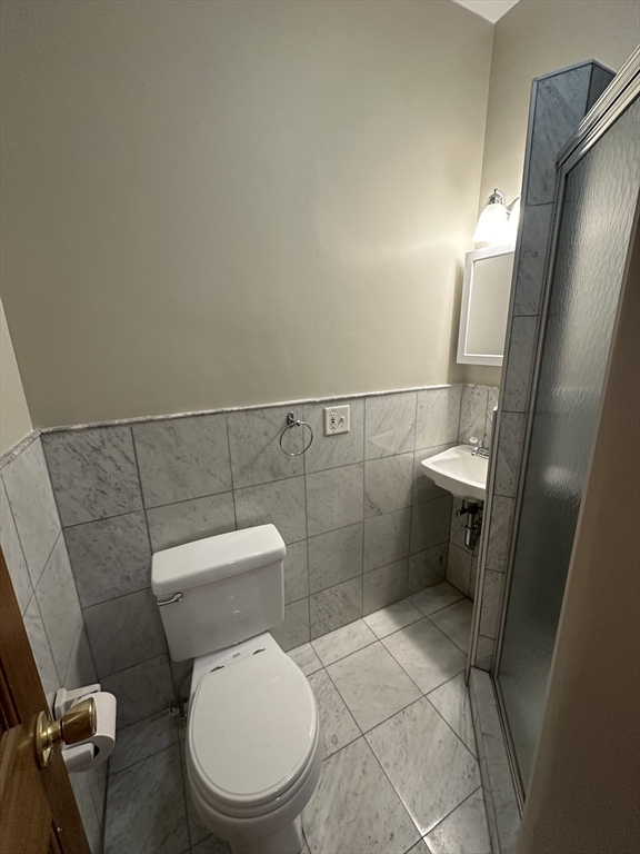57 Gainsborough Street, Unit 2 Boston, MA 02115 - Photo 5 of 8 a white toilet sitting next to a shower in a bathroom