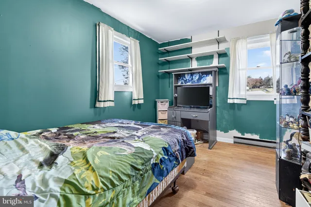 a bedroom with a bed a flat screen tv and balcony view