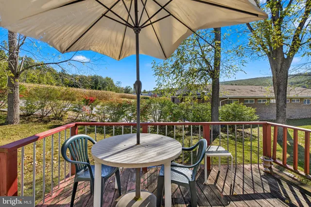 a view of a balcony with furniture and umbrella