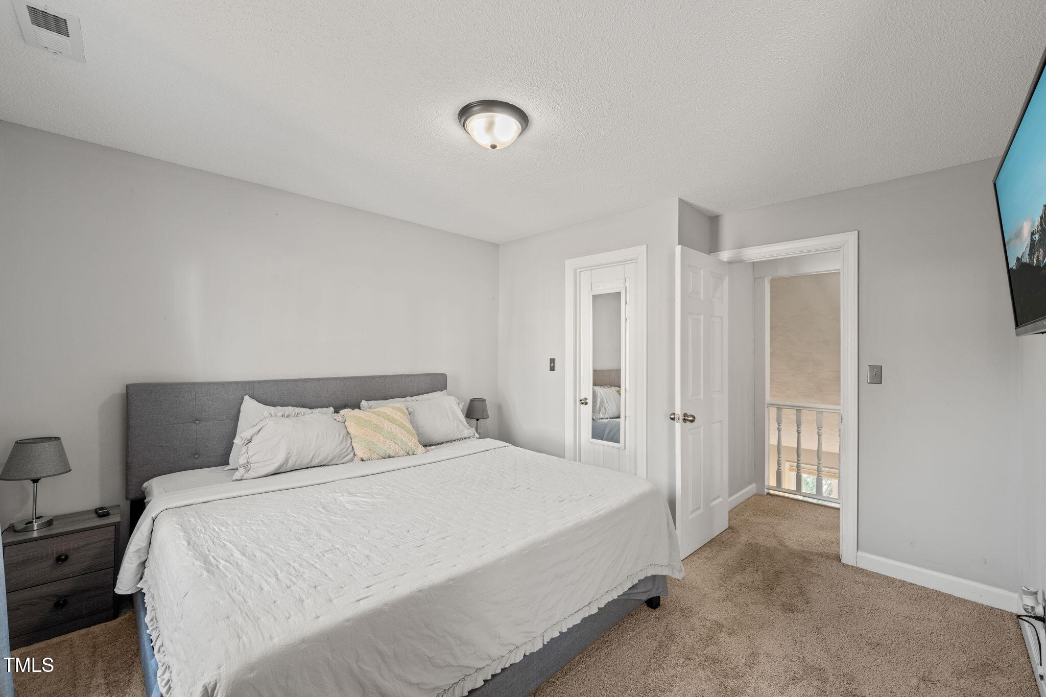 3701 East Jameson Road Raleigh, NC 27604 - Photo 19 of 26 a bedroom with a bed and a refrigerator