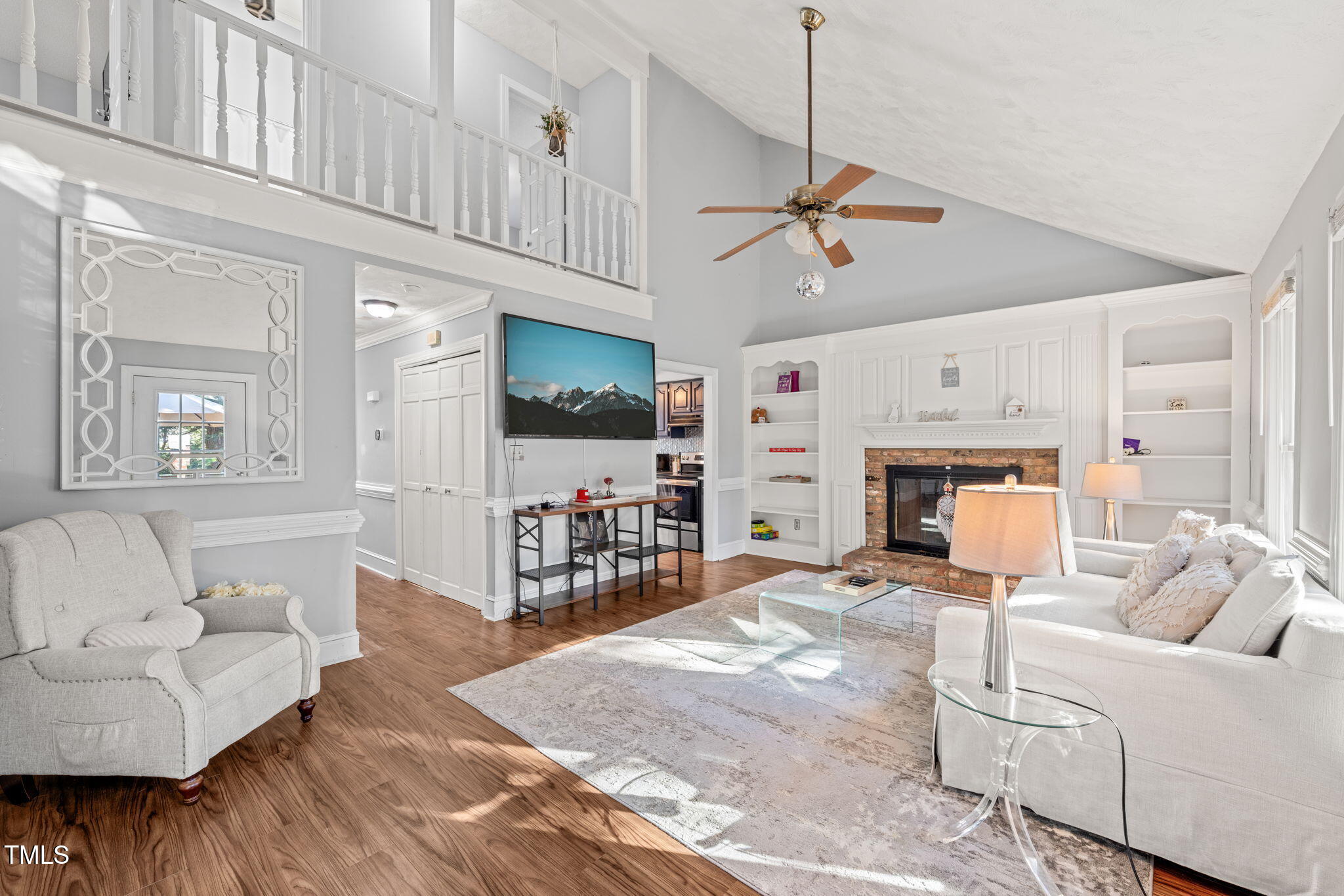 3701 East Jameson Road Raleigh, NC 27604 - Photo 3 of 26 a living room with furniture a fireplace and a flat screen tv