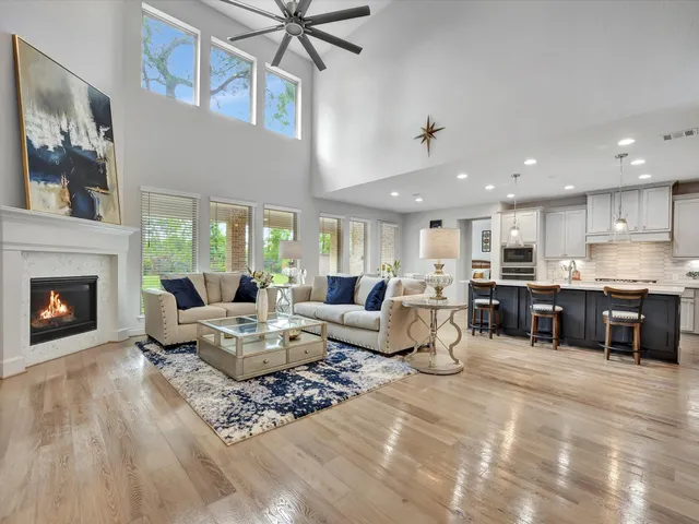 a living room with furniture kitchen view and a fireplace