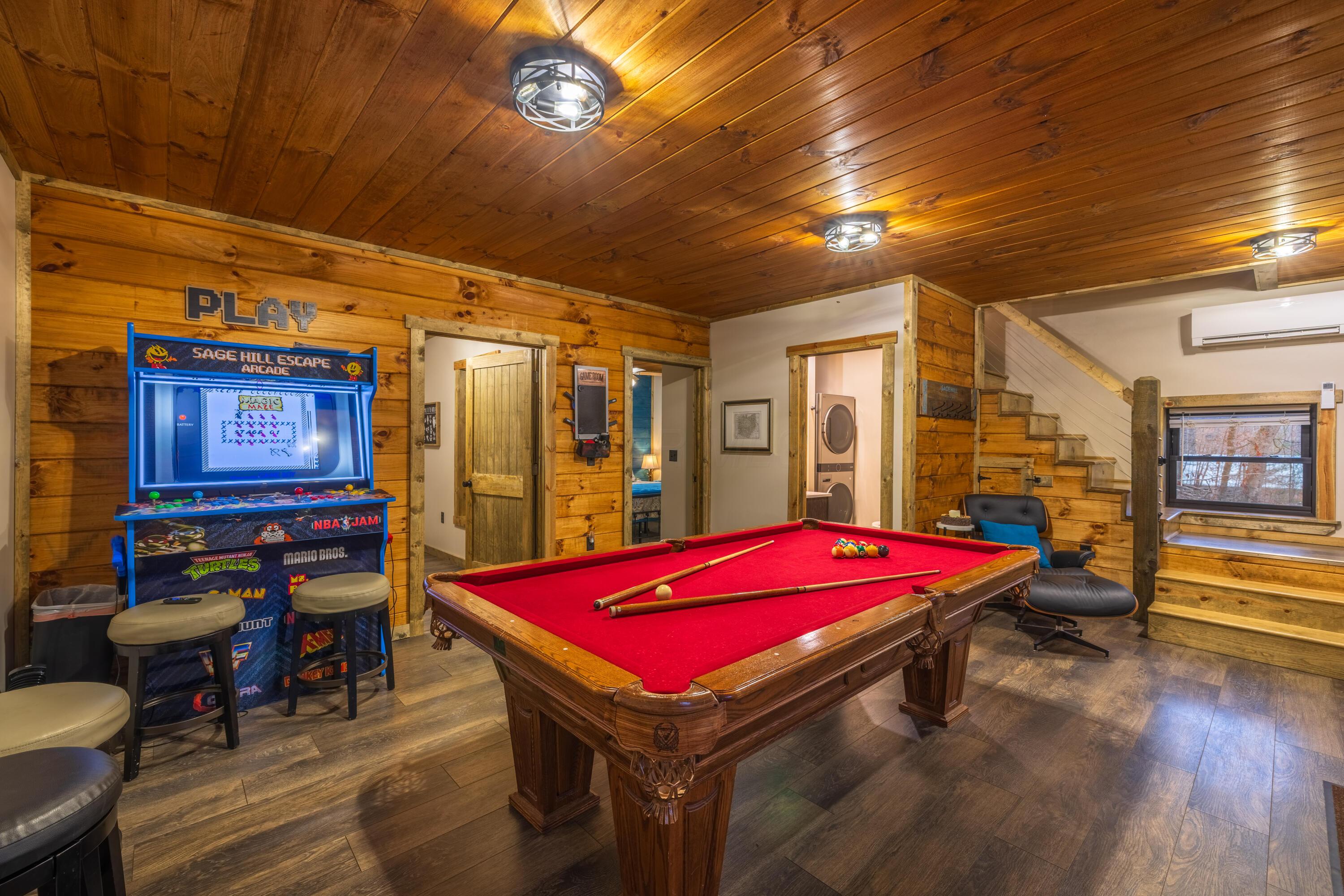 344 Skaggs Road Londonderry, OH 45647 - Photo 16 of 57 Sage Hill Escape lower level walk out basement entertainment room with pool table/ping pong table combo, arcade gaming system with over 200 games, and board games to entertain everyone in the family!