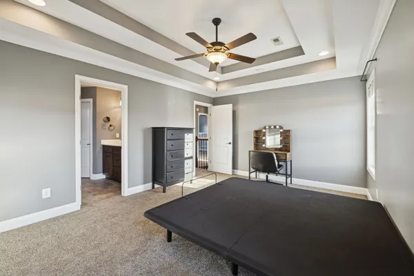 a work room with furniture and a ceiling fan