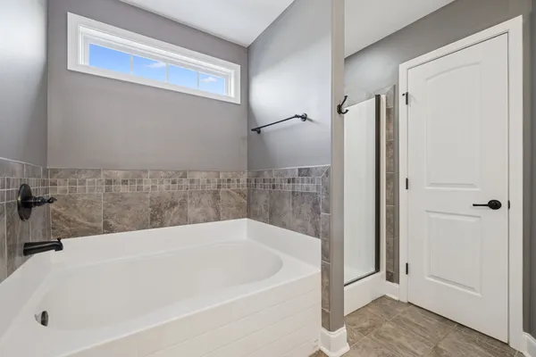 a white bath tub sitting next to a white sink