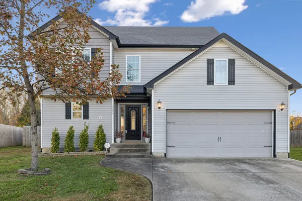 a front view of a house with a yard and garage