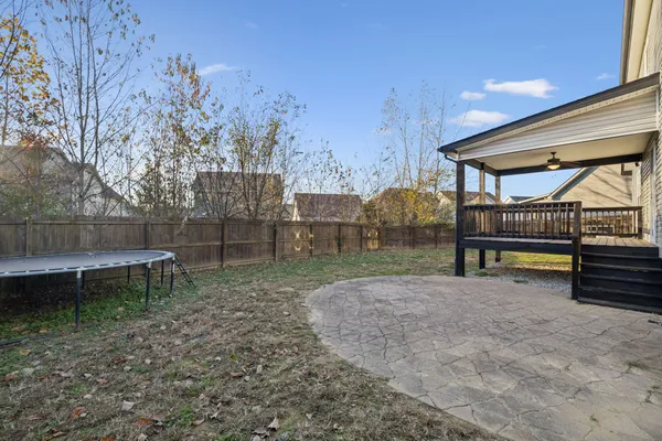 a view of backyard with wooden fence
