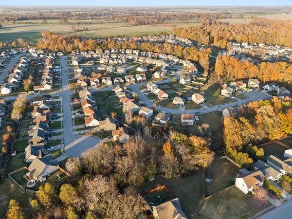 an aerial view of residential building with outdoor space and ocean view