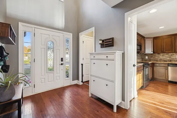 a kitchen with cabinets and wooden floor