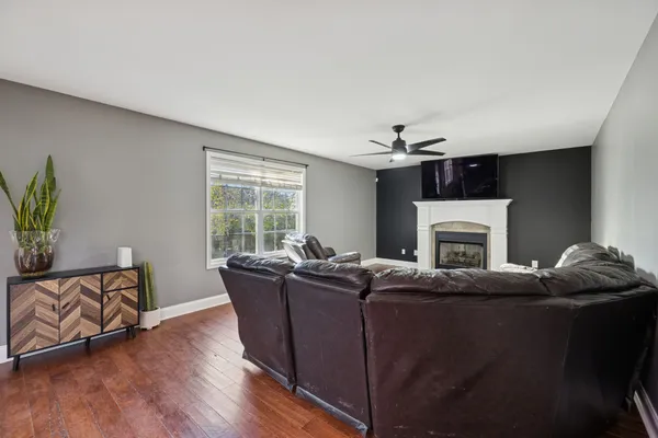 a living room with furniture a fireplace and a flat screen tv