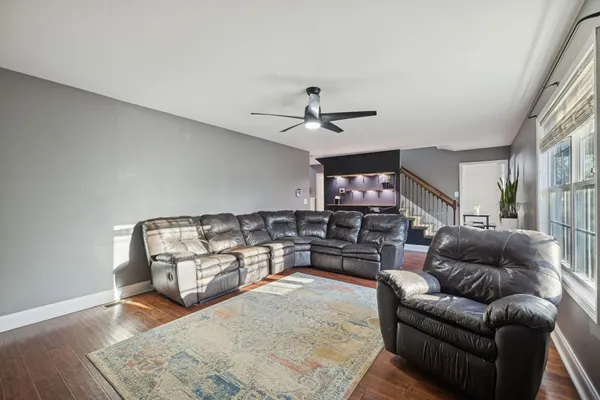 a living room with furniture and wooden floor