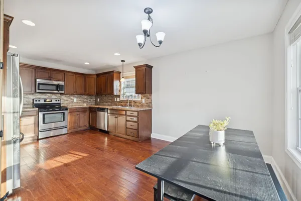 a kitchen with a sink a kitchen island and stainless steel appliances