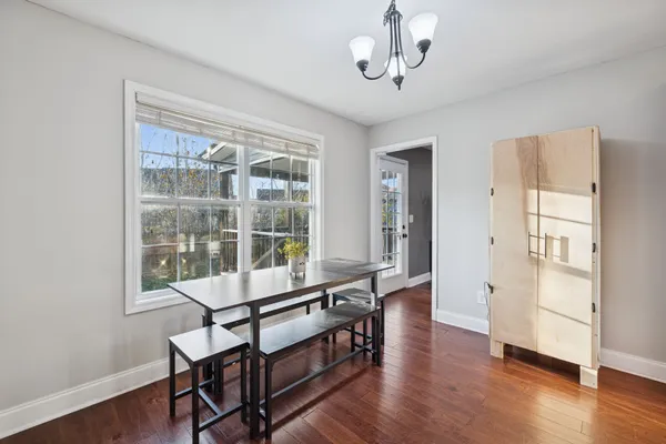 a room with wooden floor and windows
