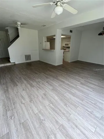 an empty room with wooden floor and white walls