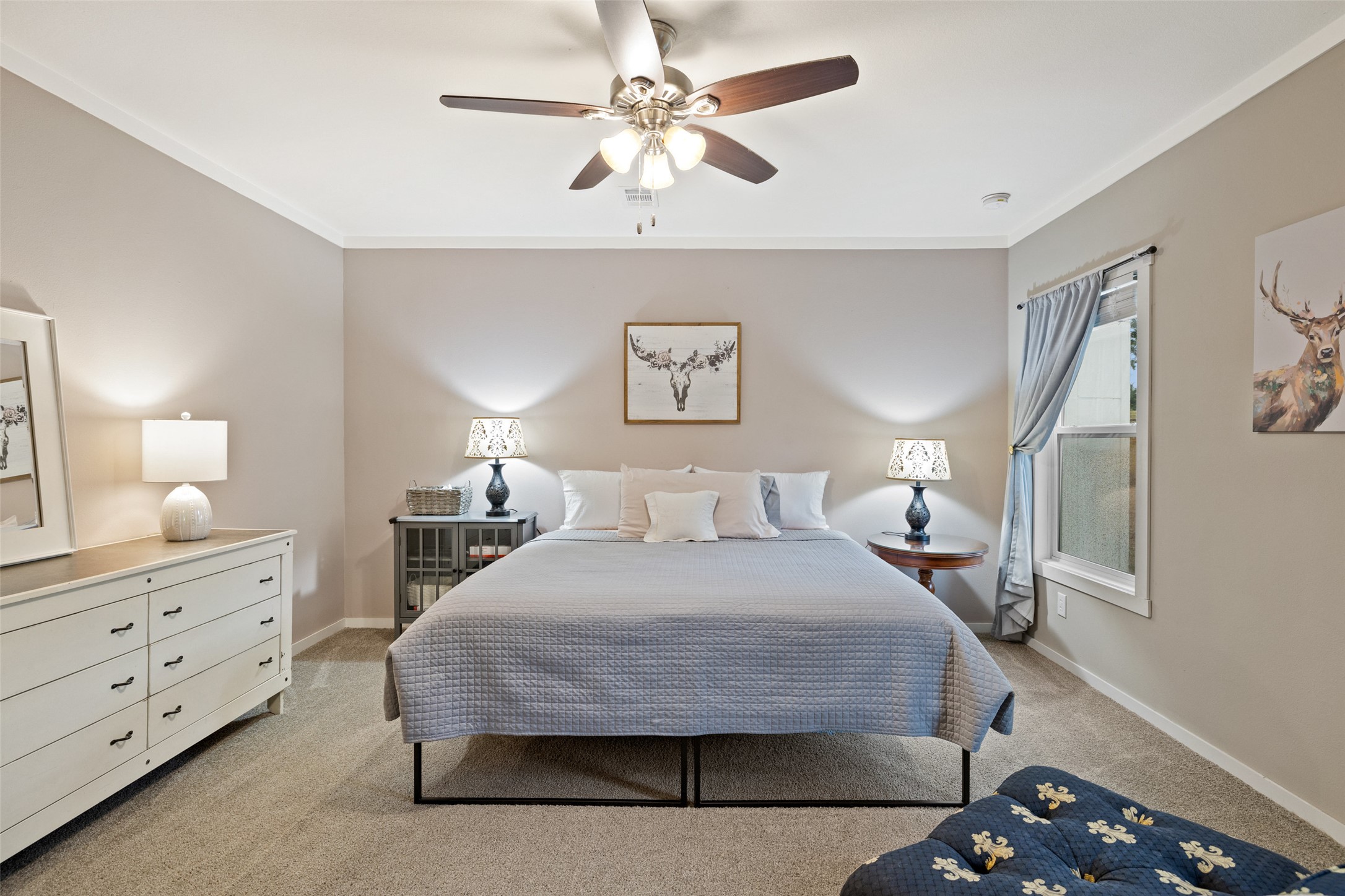 830 Ulrich Road Johnson City, TX 78636 - Photo 27 of 40 Comfortable bedroom with crown molding and soft, neutral tones.