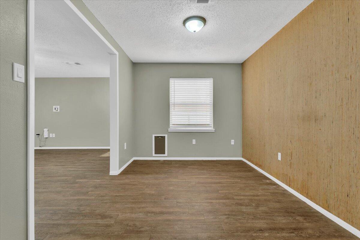 4802 54th Street Lubbock, TX 79414 - Photo 11 of 27 wooden floor in an empty room with a window