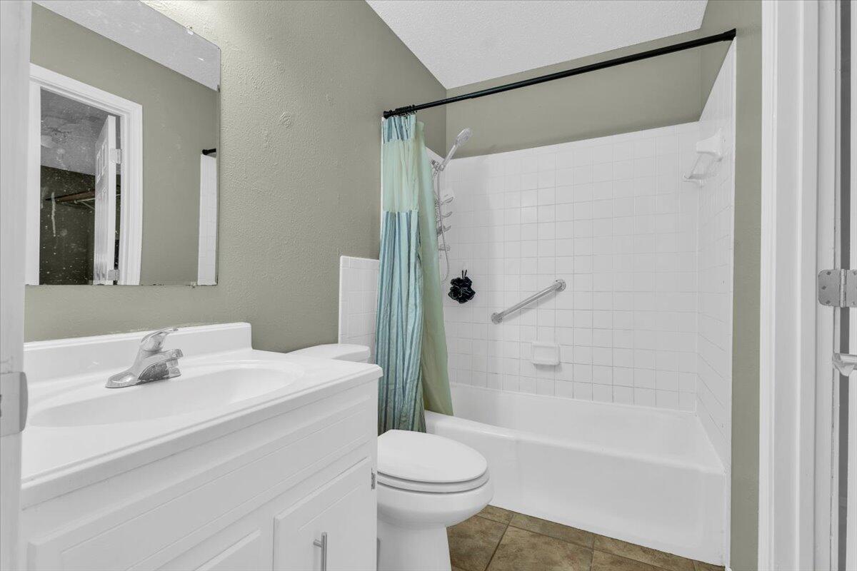 4802 54th Street Lubbock, TX 79414 - Photo 15 of 27 a bathroom with a sink toilet and shower