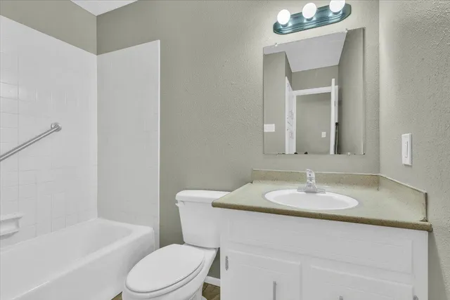 a bathroom with a sink toilet a mirror and shower