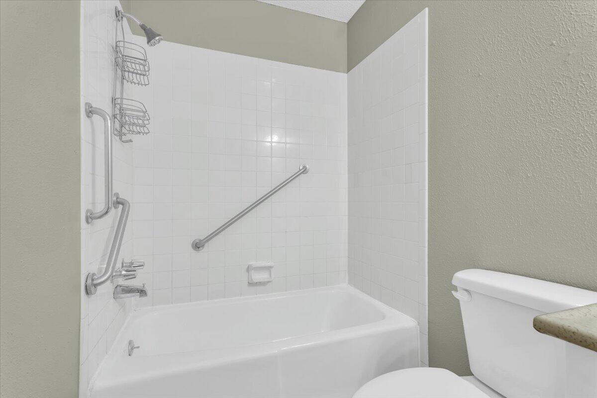 4802 54th Street Lubbock, TX 79414 - Photo 20 of 27 a white bath tub sitting next to a white toilet