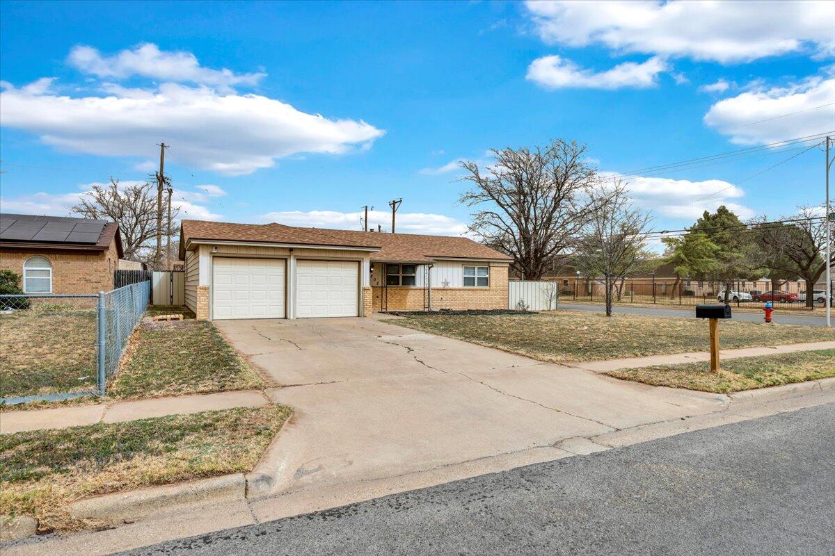 4802 54th Street Lubbock, TX 79414 - Photo 2 of 27 a front view of a house with a yard