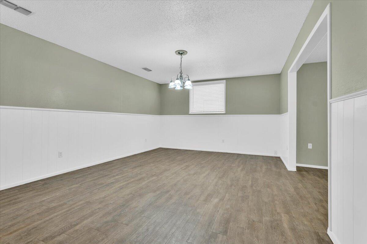 4802 54th Street Lubbock, TX 79414 - Photo 5 of 27 a view of an empty room with window and chandelier