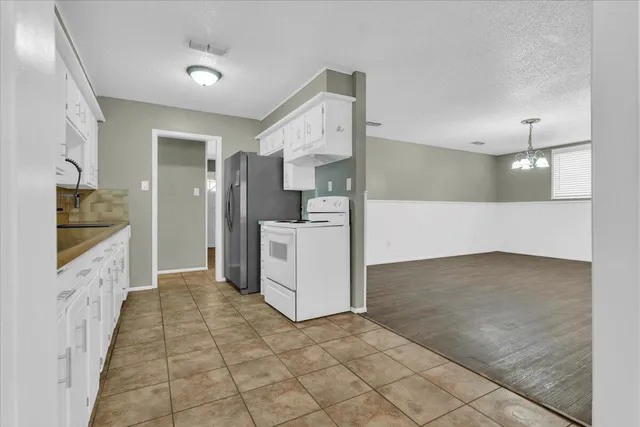 a large kitchen with cabinets and stainless steel appliances