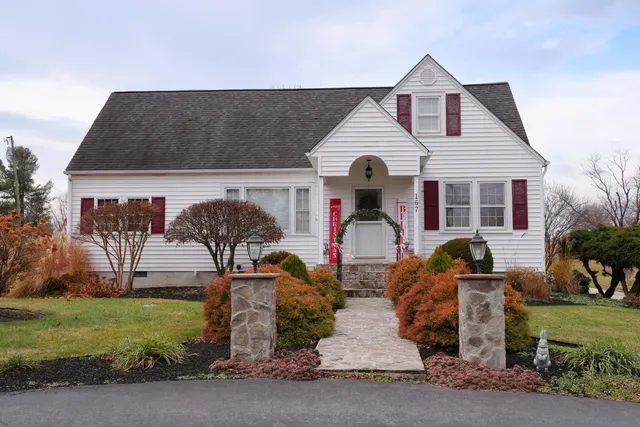 a front view of house with outdoor seating and garden