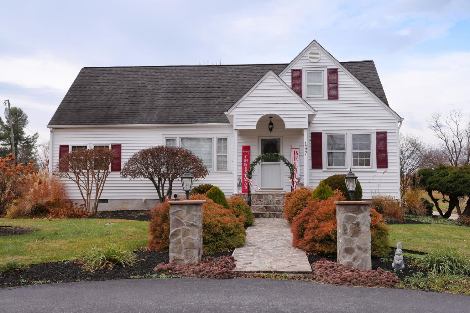 a front view of house with outdoor seating and garden