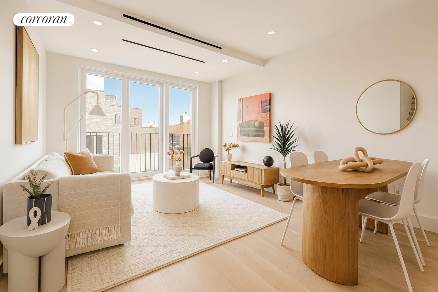 a living room with dining room and white furniture