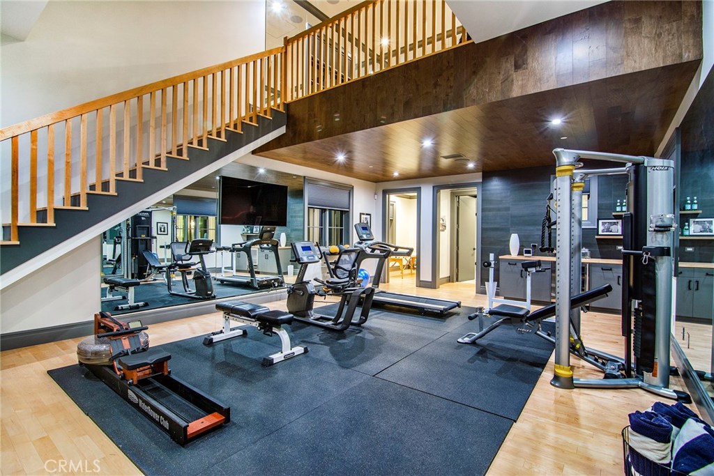 5546 Jed Smith Road Hidden Hills, CA 91302 - Photo 25 of 73 a living room with lots of furniture stairs and a large window