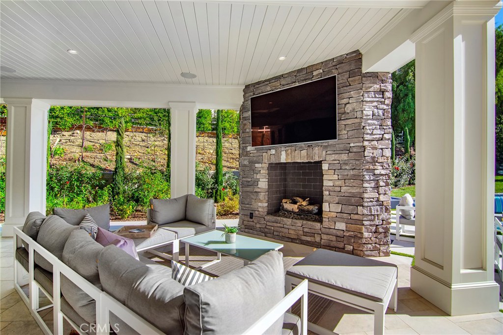 5546 Jed Smith Road Hidden Hills, CA 91302 - Photo 43 of 73 a living room with furniture a flat screen tv and a fireplace