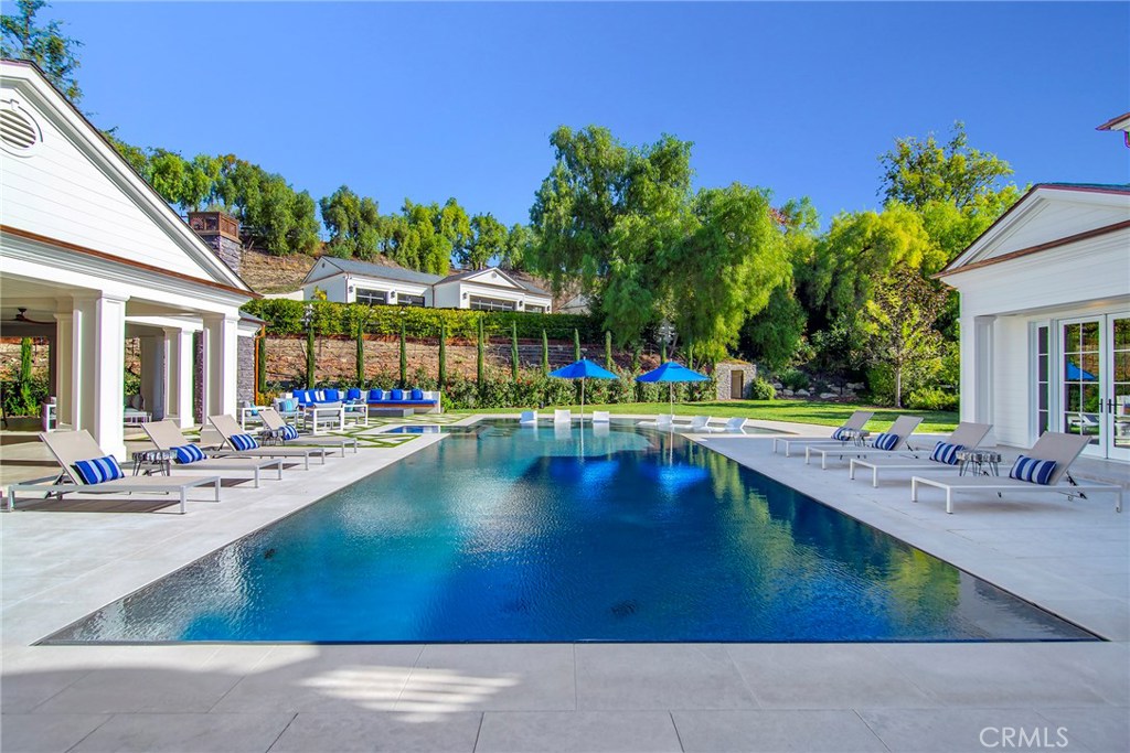 5546 Jed Smith Road Hidden Hills, CA 91302 - Photo 47 of 73 a view of a swimming pool with outdoor seating and plants