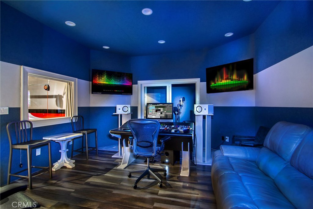 5546 Jed Smith Road Hidden Hills, CA 91302 - Photo 64 of 73 a living room with furniture and a flat screen tv