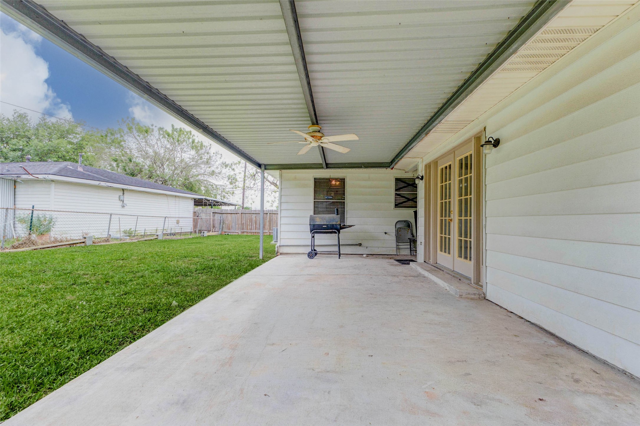411 Burke Road Pasadena, TX 77506 - Photo 23 of 24 a view of a patio with table and chairs and a barbeque