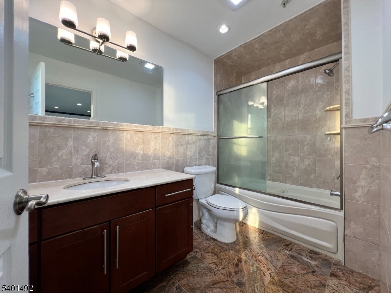 614 Fairview Avenue, Unit E Fairview, NJ 07022 - Photo 12 of 14 a bathroom with a sink and a mirror