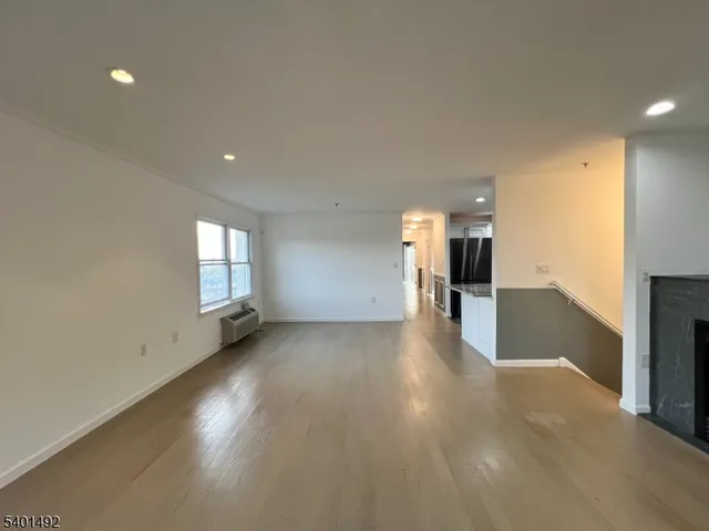a view of a big room with windows and chandelier