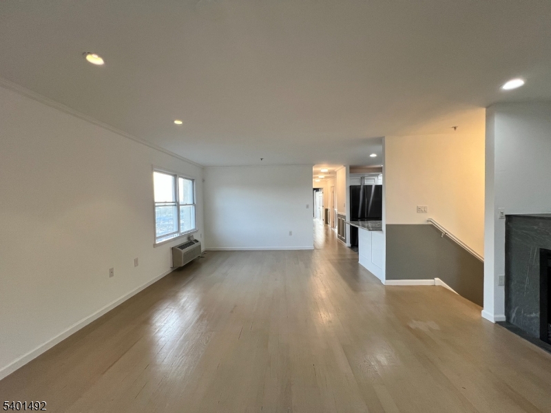 614 Fairview Avenue, Unit E Fairview, NJ 07022 - Photo 3 of 14 a view of a big room with windows and chandelier