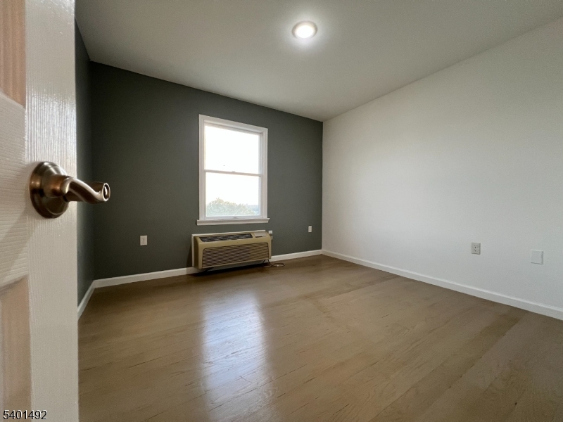 614 Fairview Avenue, Unit E Fairview, NJ 07022 - Photo 6 of 14 a view of a room with window and a ceiling fan