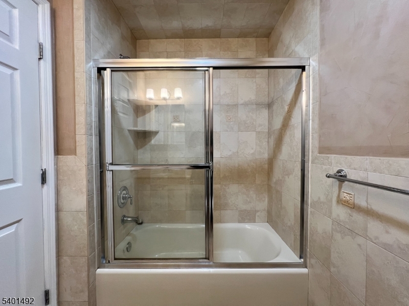 614 Fairview Avenue, Unit E Fairview, NJ 07022 - Photo 9 of 14 a bathroom with a glass shower door