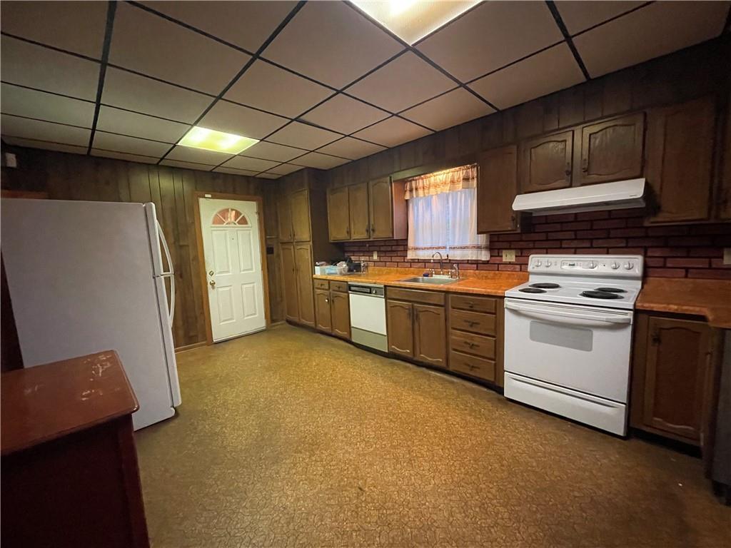 4551 Hollow Road New Castle, PA 16101 - Photo 9 of 21 a kitchen with a stove sink and a refrigerator