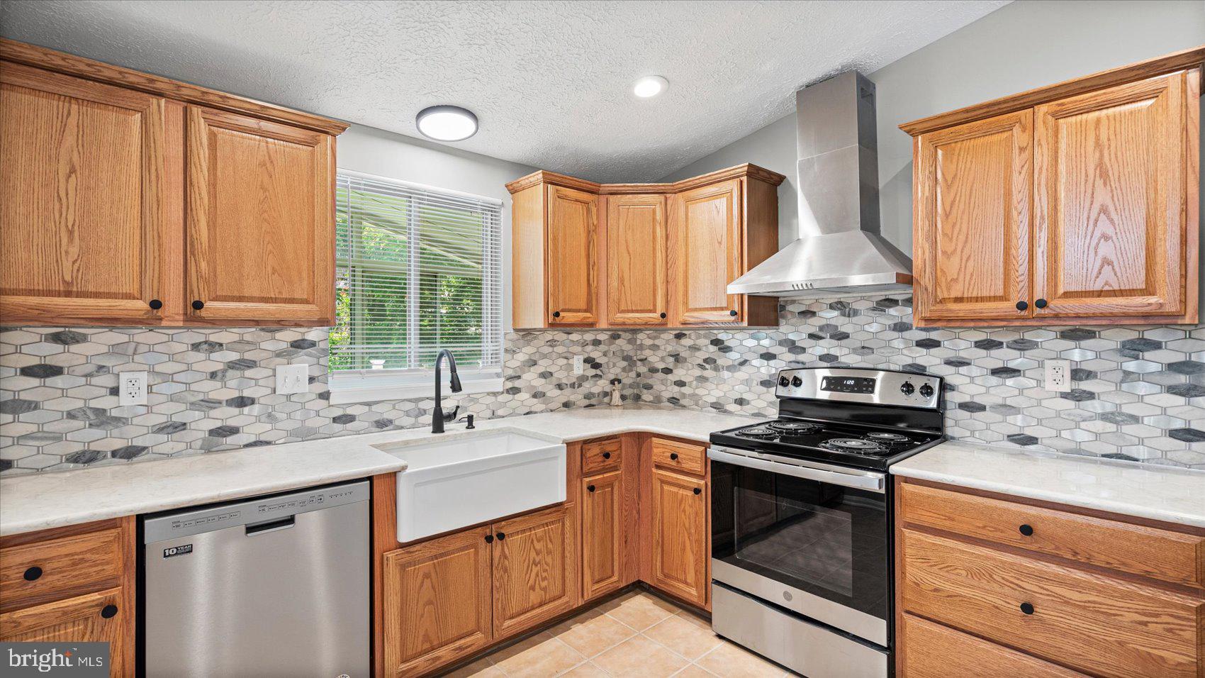 3709 Redberry Way Nottingham, MD 21236 - Photo 13 of 45 a kitchen with stainless steel appliances a sink stove and cabinets