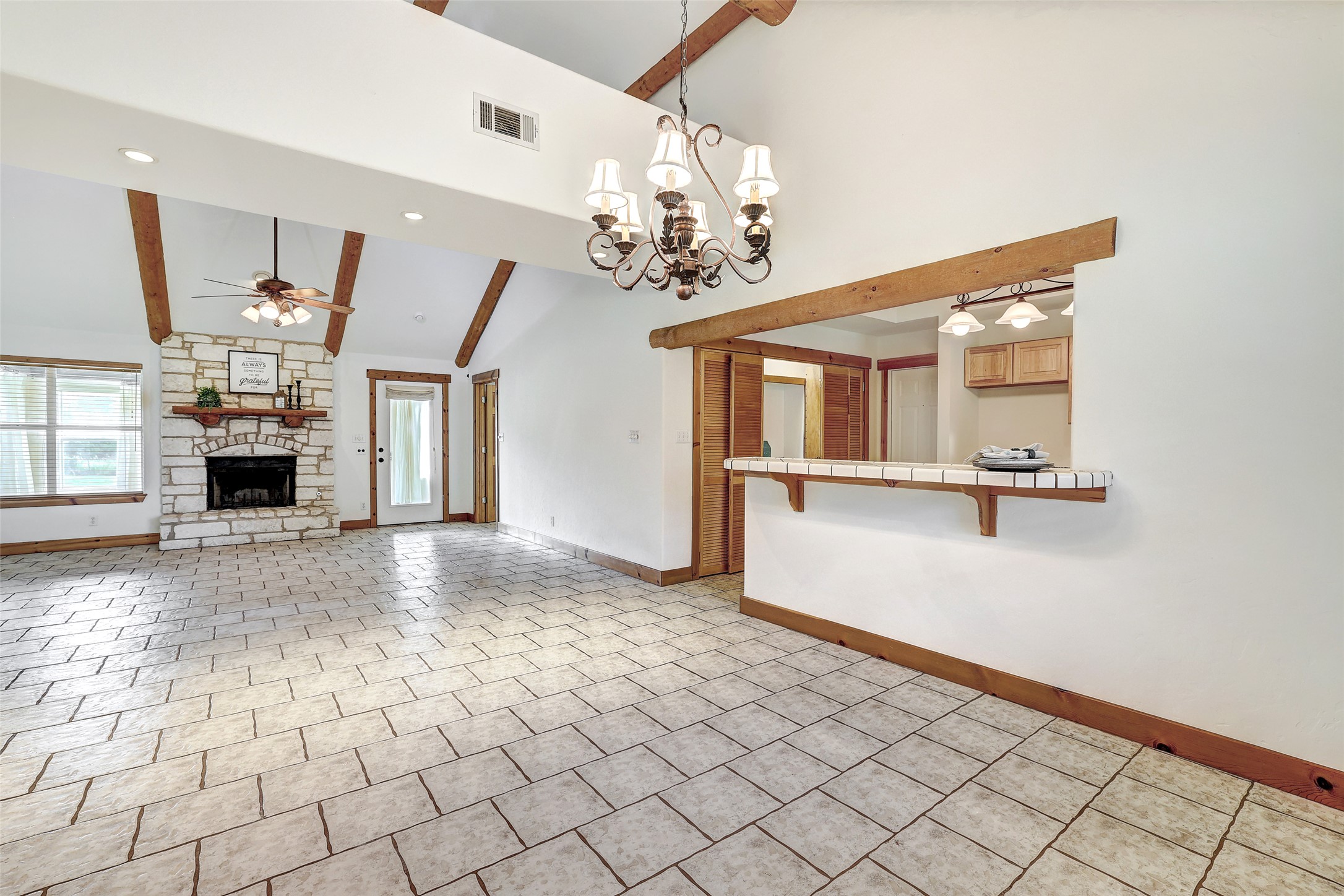 125 Kyle Lane Georgetown, TX 78633 - Photo 13 of 34 Unfurnished living room featuring ceiling fan, a fireplace, a chandelier, and lofted ceiling