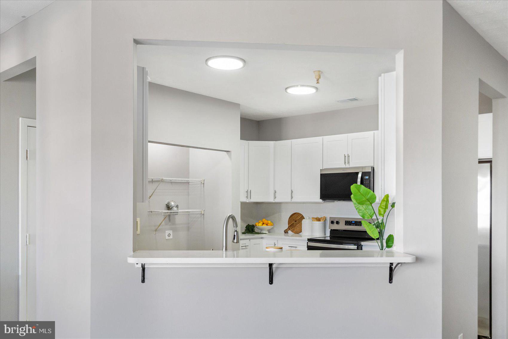 5386 Glenthorne Court, Unit 5386 Baltimore, MD 21237 - Photo 11 of 36 a kitchen with a sink a counter space and appliances