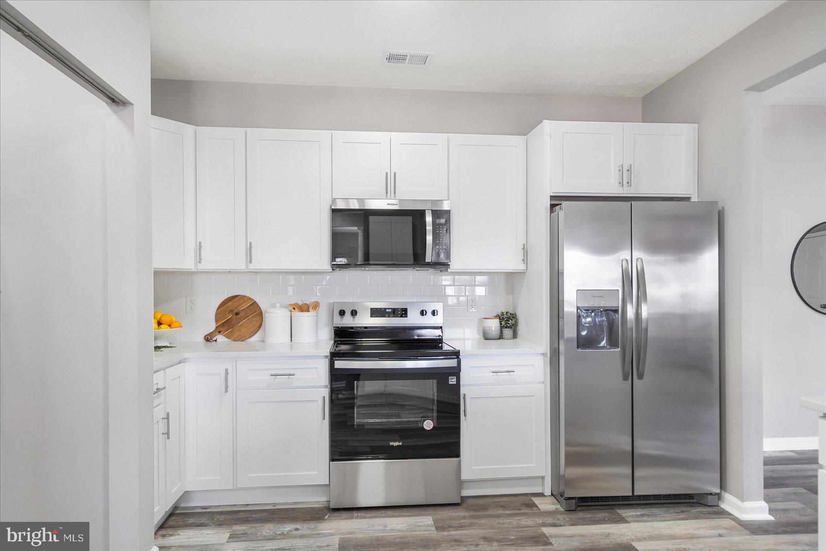 5386 Glenthorne Court, Unit 5386 Baltimore, MD 21237 - Photo 12 of 36 a kitchen with stainless steel appliances a refrigerator stove and sink