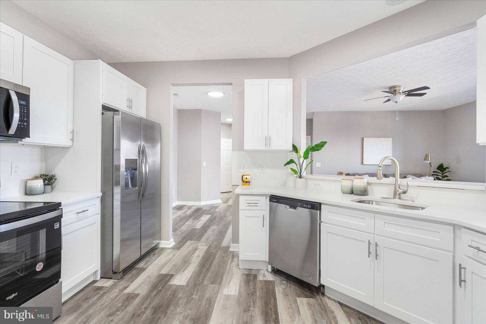 5386 Glenthorne Court, Unit 5386 Baltimore, MD 21237 - Photo 13 of 36 a kitchen with a sink stainless steel appliances and cabinets