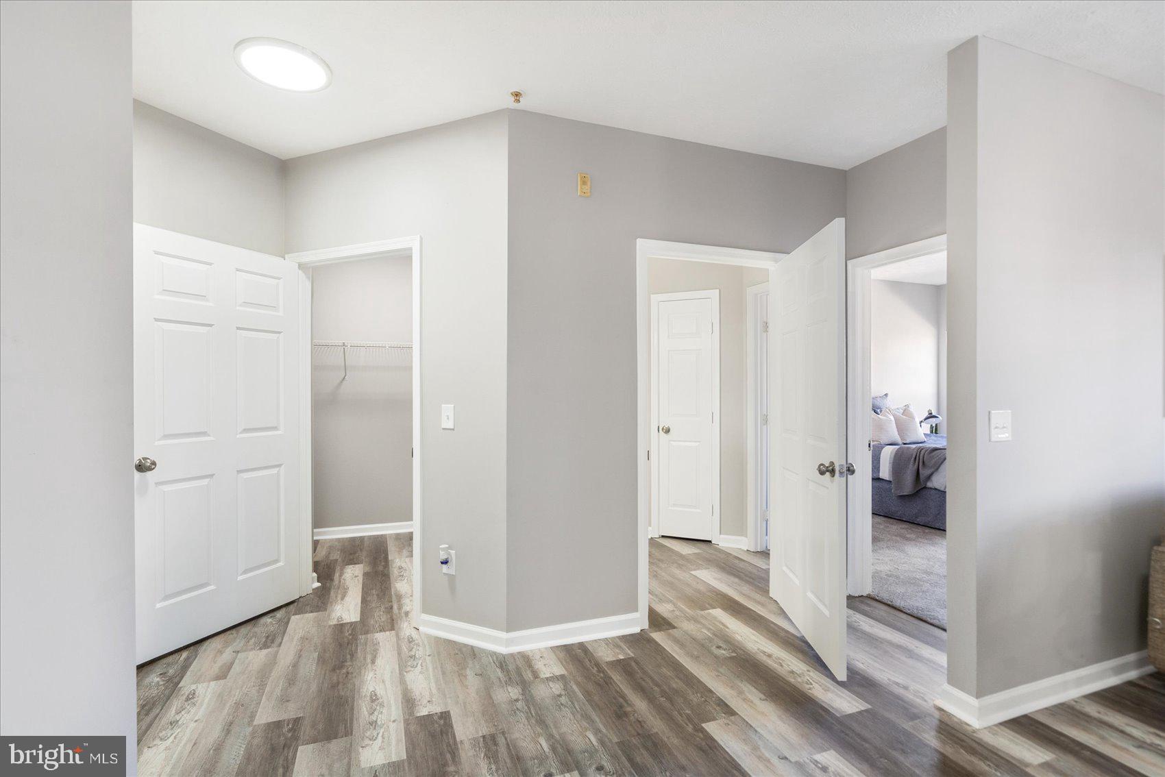 5386 Glenthorne Court, Unit 5386 Baltimore, MD 21237 - Photo 21 of 36 a view of a hallway with wooden floor and closet area