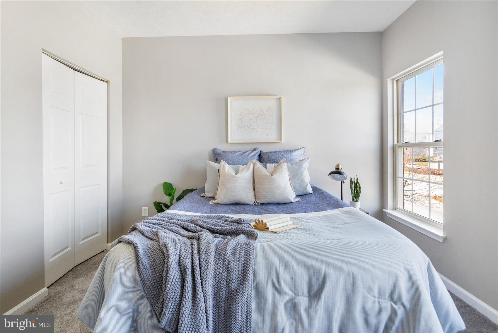 5386 Glenthorne Court, Unit 5386 Baltimore, MD 21237 - Photo 23 of 36 a bed sitting in a bedroom next to a window