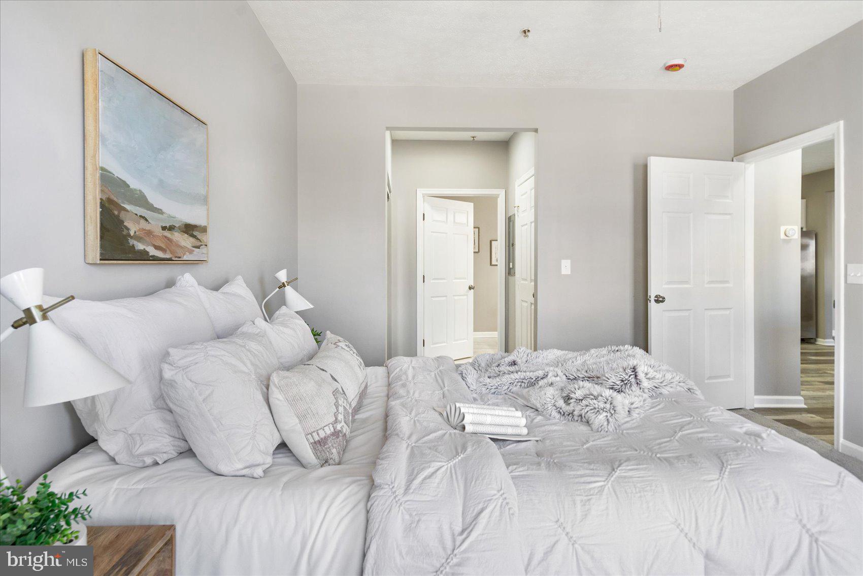 5386 Glenthorne Court, Unit 5386 Baltimore, MD 21237 - Photo 28 of 36 a bedroom with a bed and a painting on the wall