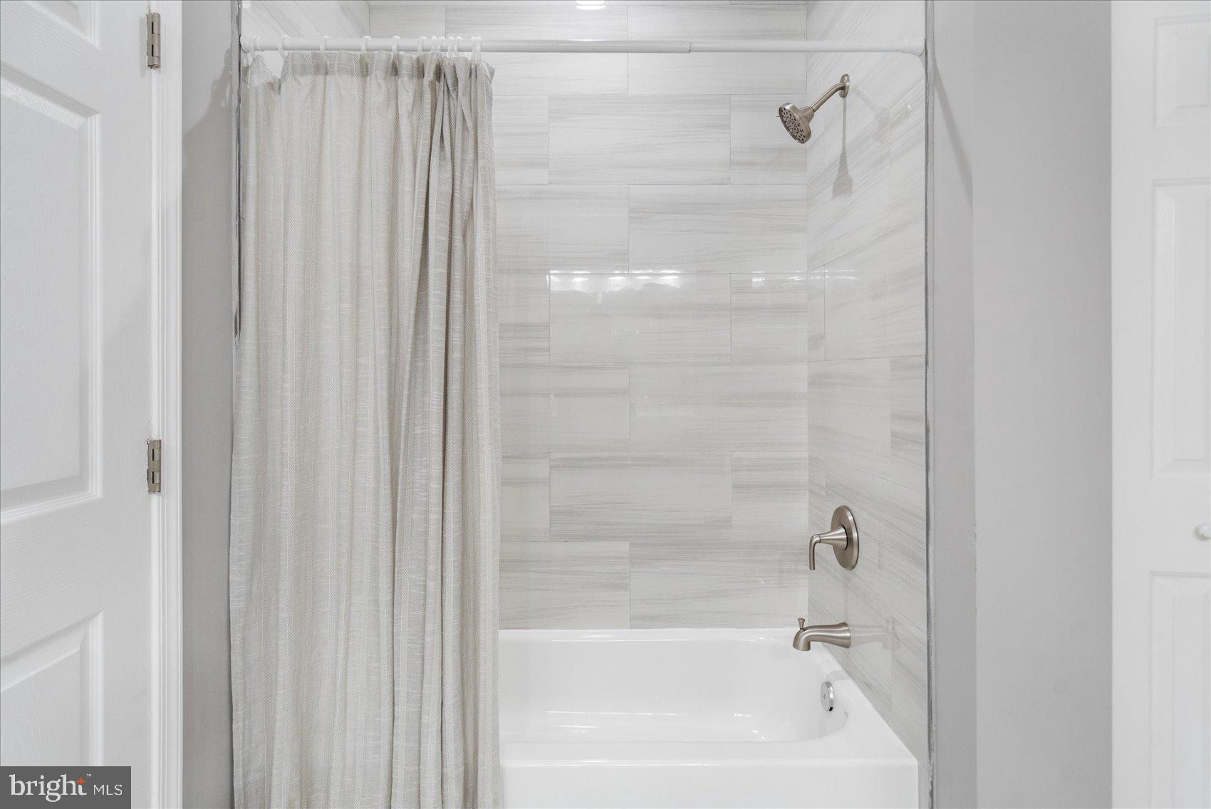 5386 Glenthorne Court, Unit 5386 Baltimore, MD 21237 - Photo 30 of 36 a close up of a bathtub curtain