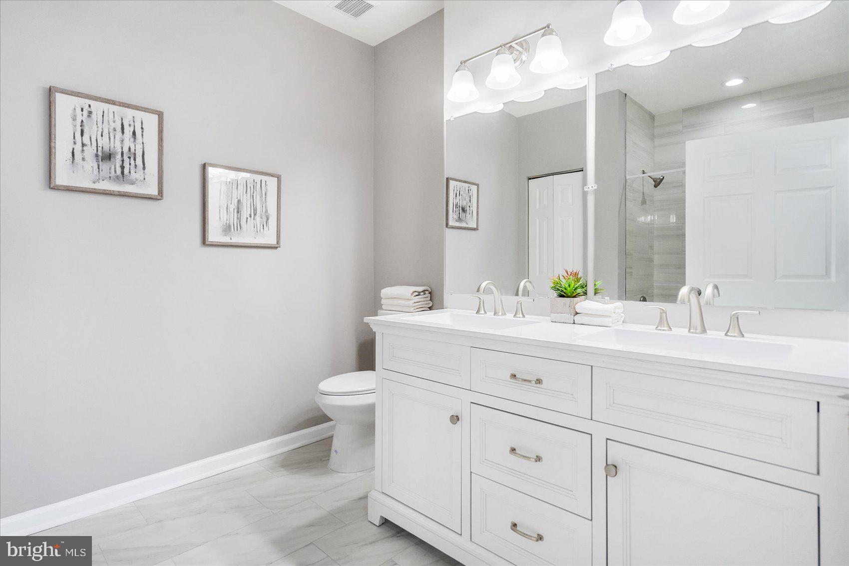 5386 Glenthorne Court, Unit 5386 Baltimore, MD 21237 - Photo 31 of 36 a bathroom with a toilet sink and mirror